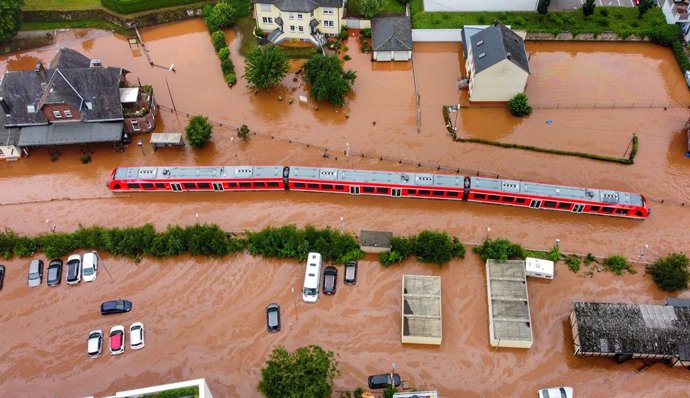 15 July 2021, Rhineland-Palatinate, Kordel: An aerial view shows a regional train is submerged in water at the local station after raging floods engulfed parts of western Germany. Photo: Sebastian Schmitt/dpa