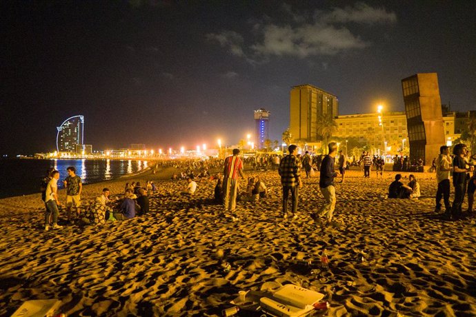 Joves es reuneixen en la platja de la Barceloneta hores abans que entri en vigor el toc de queda a Catalunya