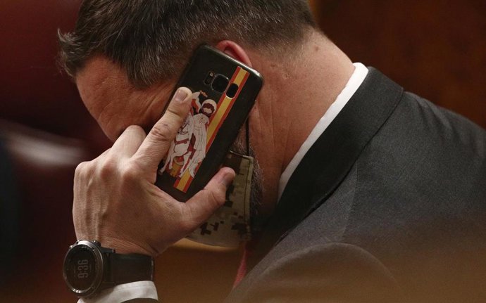 Archivo - El líder de Vox, Santiago Abascal, habla por teléfono durante una sesión plenaria