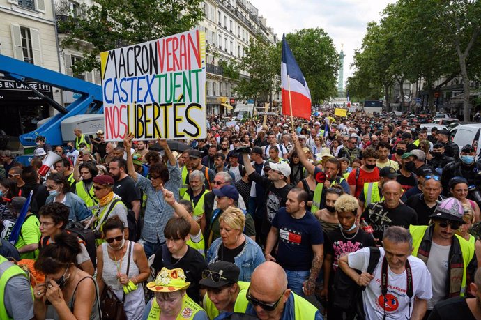 24 July 2021, France, Paris: People holds placards and flags during a demonstration at the Place de la Bastille with the Yellow Vests against the health pass imposed by the government. Photo: Julien Mattia/Le Pictorium Agency via ZUMA/dpa