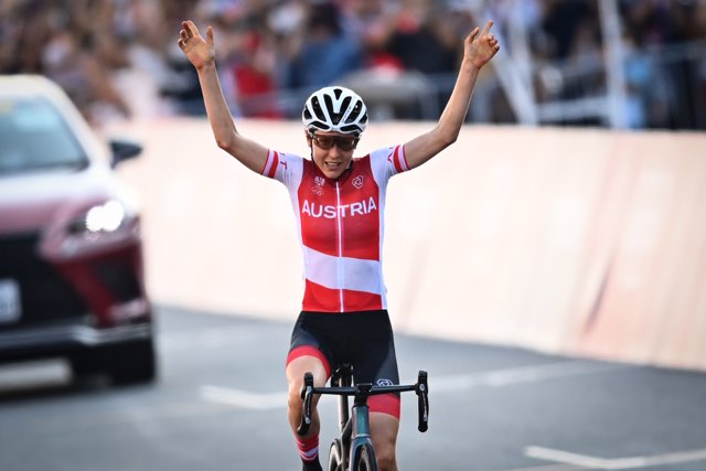 25 July 2021, Japan, Gotemba: Austria's Anna Kiesenhofer celebrates as she crosses the finish line to win the women's cycling road race of the Tokyo 2020 Olympic Games at the Fuji International Speedway. Photo: Jasper Jacobs/BELGA/dpa