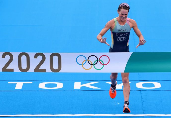 27 July 2021, Japan, Tokyo: Bermuda's Flora Duffy celebrates as she crosses the finish line to win the the Women's individual Triathlon competition at the Odaiba Marine Park, during the Tokyo 2020 Olympic Games. Photo: Benoit Doppagne/BELGA/dpa