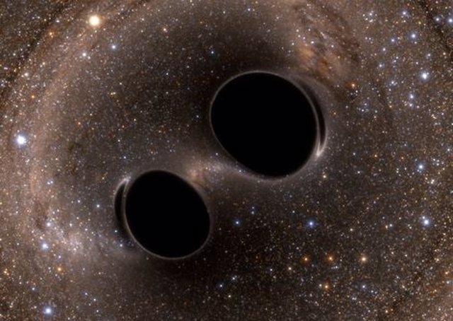 Colisión de agujeros negros liberando ondas gravitacionales