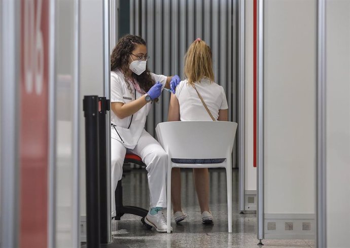 Una joven recibe la vacuna contra el Covid-19 en el dispositivo puesto en marcha en la Ciutat de les Arts i les Cincies de Valencia, a 28 de julio de 2021, en Valencia, Comunidad Valenciana, (España). Este gran punto de vacunación, uno de los puestos e