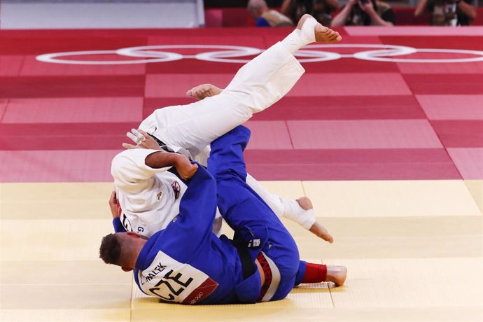 30 July 2021, Japan, Tokyo: Czech Republic's Lukas Krpalek (C) executes an Ippon on Georgia's Guram Tushishvili in the Men +100 kg Final Judo match at the Nippon Budokan Mat during the Tokyo 2020 Olympic Games. 