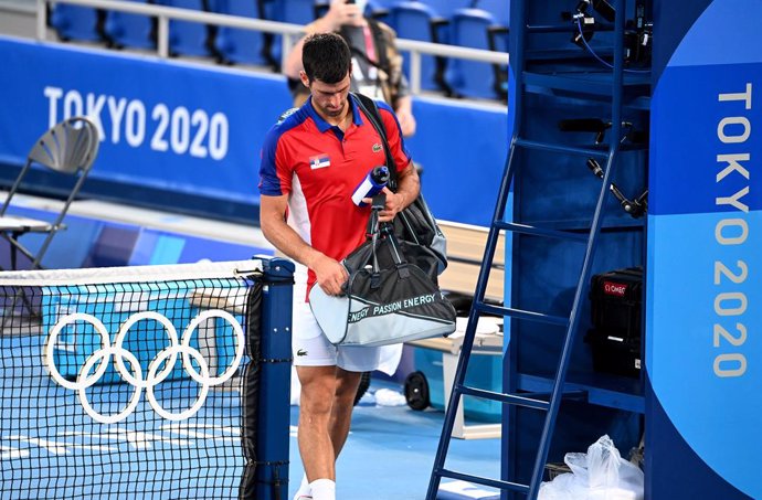 31 July 2021, Japan, Tokyo: Serbian tennis player Novak Djokovic leaves the court after being defeated against Spain's Pablo Carreno Busta in the Men's Singles Bronze Medal Match at the Ariake Tennis Centre Court, during the Tokyo 2020 Olympic Games. Ph