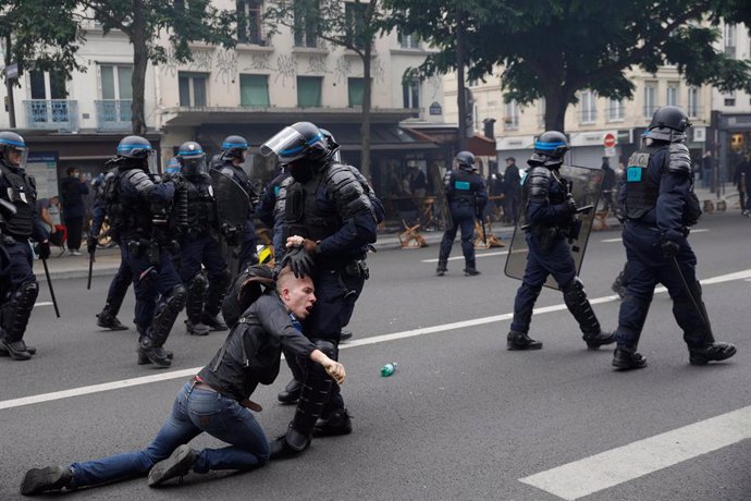 31 July 2021, France, Paris: A policeman detains a man during a demonstration held against French legislation making a COVID-19 health pass compulsory to visit a cafe, board a plane or travel on an inter-city train. The legislation passed by parliament 