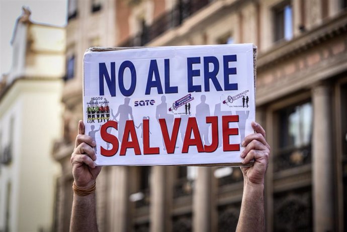 Archivo - Una persona sostiene una pancarta donde se puede leer "No al ERE salvaje" en una protesta organizada contra CaixaBank por el ERE para miles de empleados, a 22 de junio de 2021, en Valencia, Comunidad Valenciana, (España). 