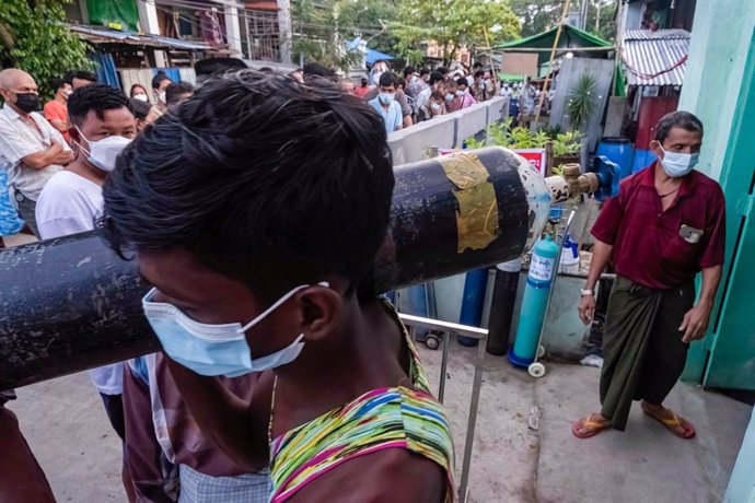 Decenas de personas hacen cola en Birmania para rellenar las bombonas de oxígeno.