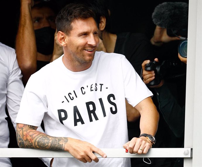 10 August 2021, France, Paris: Argentinian footballer Lionel Messi smiles at supporters of Paris Saint-Germain upon landing at Le Bourget airport following his departure from Barcelona.PSG is looking forward to complete the 34-year-old signing following