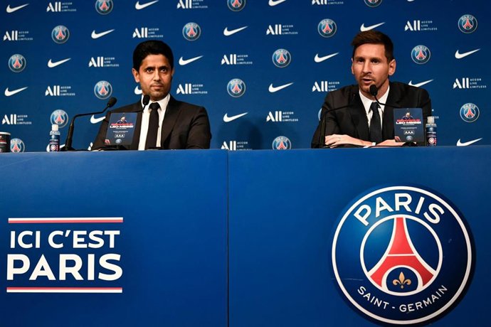 Paris Saint-Germain's president Nasser Al-Khelaifi (L) listens on, as Argentinian football player Lionel Messi speaks at a press conference during his official unveiling at the French football club Paris Saint-Germain's (PSG) Parc des Princes stadium.