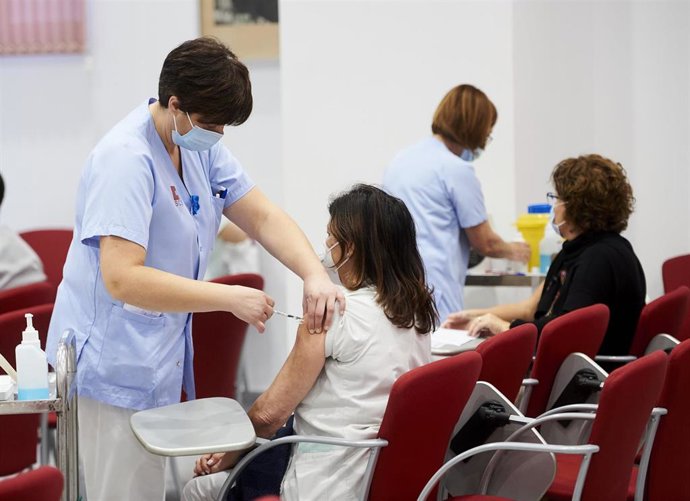 Archivo - Un trabajadora sanitaria inyecta la segunda dosis de la vacuna de Pfizer.- Archivo