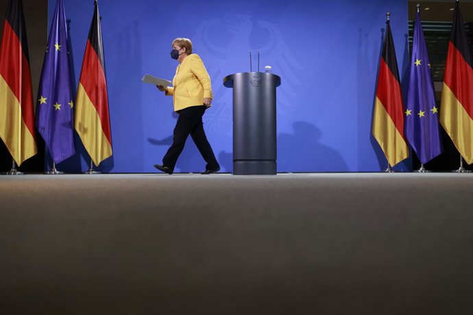 16 August 2021, Berlin: German Chancellor Angela Merkel leaves after giving a statement about current developments in Afghanistan at a press conference in the Chancellery. Photo: Odd Andersen/AFP POOL/dpa