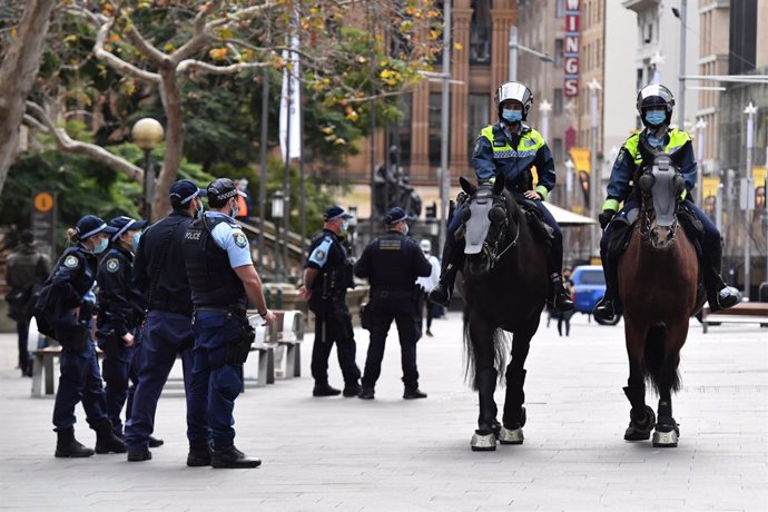 NSW police patrol George St in front of the Sydney Town Hall in anticipation of an anti-lockdown rally in Sydney Sydney, Saturday, July 31, 2021. (AAP Image/Mick Tsikas) NO ARCHIVING