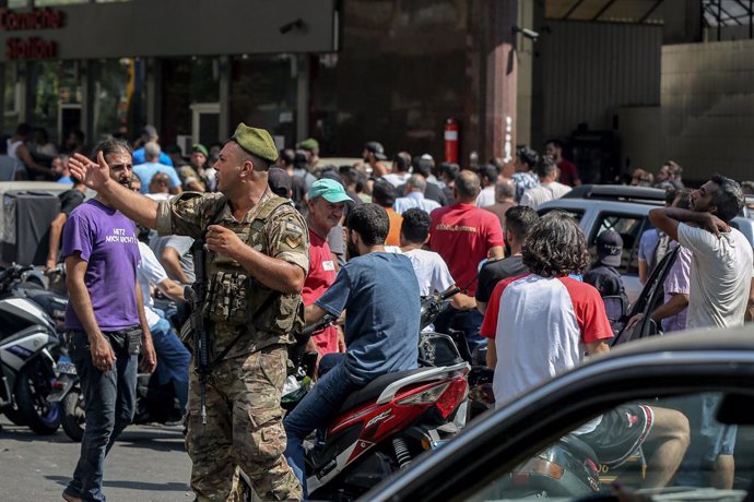 14 August 2021, Lebanon, Beirut: A Lebanese army soldier supervises entry of motorists and vehicles at a gas station in Beirut to curb fuel hoarding, as central bank chief Riad Salamehannounced this week that he would no longer be able to subsidize fue