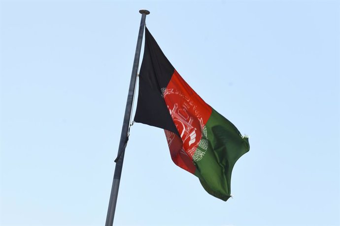 The Afghan flag is seen flying at the Embassy of the Islamic Republic of Afghanistan in Canberra, Monday, August 16, 2021. (AAP Image/Lukas Coch) NO ARCHIVING