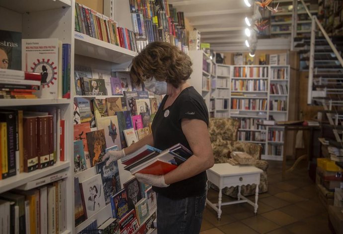 Archivo - Una trabajadora de una librería sevillana, foto de recurso
