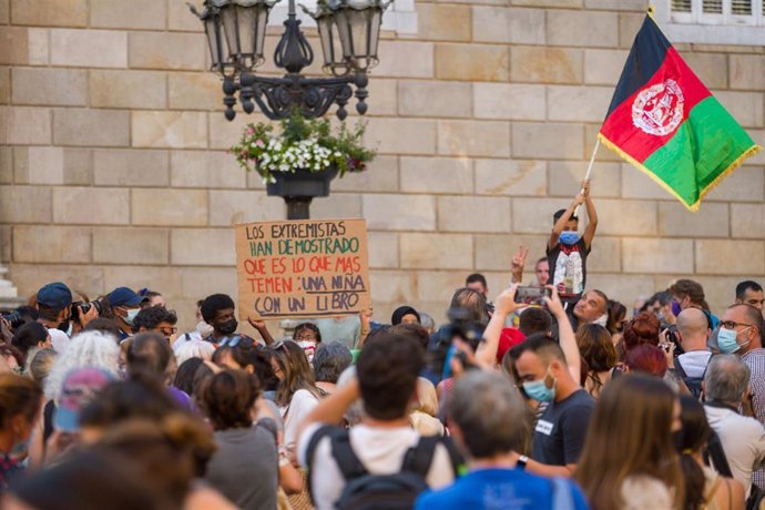 Varias personas participan en una concentración en solidaridad con las mujeres y niñas afganas en la plaza de Sant Jaume de Barcelona, a 18 de agosto de 2021, en Barcelona, Cataluña (España).
