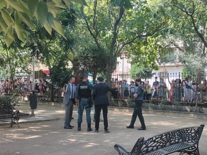 Miembros de las fuerzas de seguridad en el parque Casto Lozano de Navalmoral , frente a los vecinos que aguardan tras las vallas.