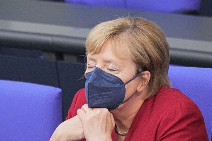 25 August 2021, Berlin: German Chancellor Angela Merkel sits with her eyes closed at the special session of the German Bundestag on the situation in Afghanistan. Photo: Michael Kappeler/dpa