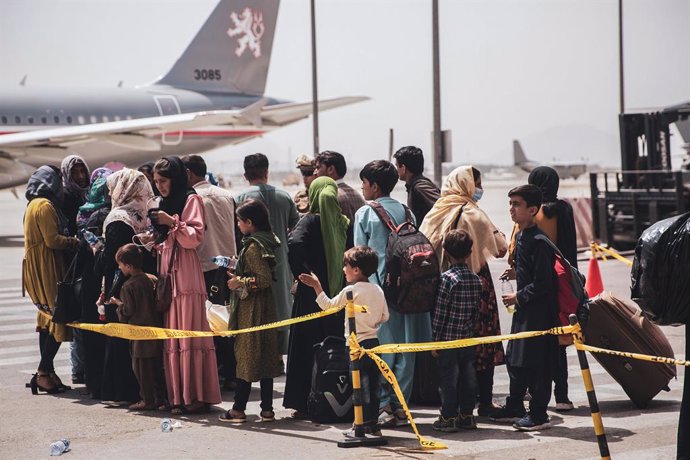 FILED - 18 August 2021, Afghanistan, Kabul: Afghan civilians wait to board an aircraft during the evacuation process at Hamid Karzai International Airport.  The evacuation is taking place due to the tense situation in Afghanistan after the takeover of t