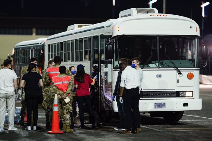 20 August 2021, Rhineland-Palatinate, Ramstein-Miesenbach: People flown out of Afghanistan welcomed by soldiers and helpers as they leave a transport bus at Ramstein Air Base. Photo: Uwe Anspach/dpa