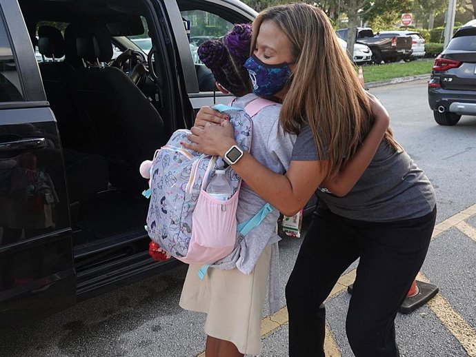 Dolphin Bay Elementary School Assistant Principal Janet Blano Soto greets students in the car line