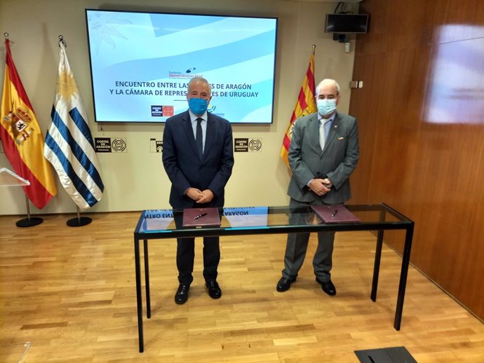 El presidente de las Cortes de Aragón, Javier Sada, y el presidente de la Cámara de Representantes del Parlamento de Uruguay, Alfredo Fratti, firman la adenda al convenio de colaboración, en el palacio de la Aljafería.