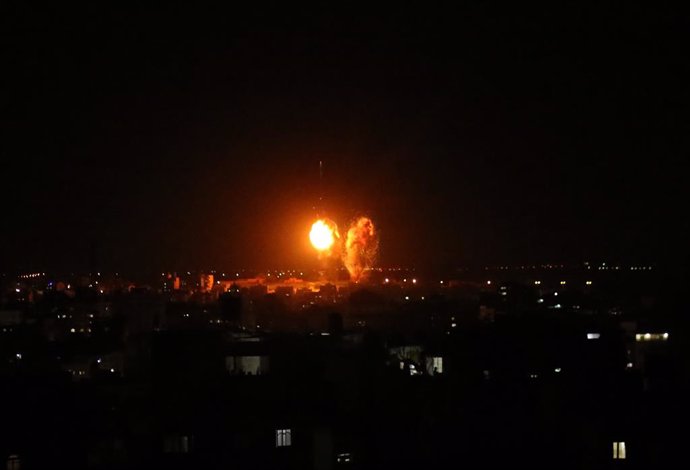Archivo - 17 June 2021, Palestinian Territories, Gaza City: Explosions light-up the night sky above buildings in Gaza City as Israeli forces shell the Palestinian enclave. The Israeli military tweeted on Thursday night that the bombardments of military 