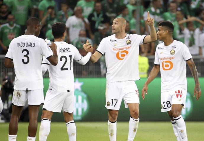 Burak Yilmaz of Lille celebrates his goal with Benjamin Andre and Reinildo Mandava during the French championship Ligue 1 football match between AS Saint-Etienne (ASSE) and Lille OSC (LOSC) on August 21, 2021 at Stade Geoffroy-Guichard in Saint-Etienne,