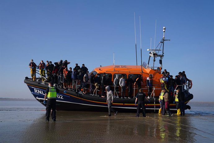 07 September 2021, United Kingdom, Dover: A group of people thought to be migrants are brought ashore from the local lifeboat at Dungeness in Kent, after being picked-up following a small boat incident in the Channel. Photo: Gareth Fuller/PA Wire/dpa