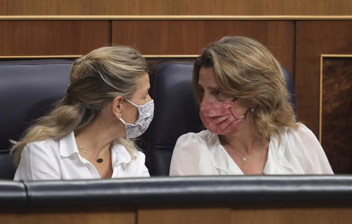 La vicepresidenta de Trabajo y Economía Social, Yolanda Díaz (i), y la vicepresidenta de Transición Ecológica y Reto Demográfico, Teresa Ribera, conversan en una sesión de control al Gobierno en el Congreso