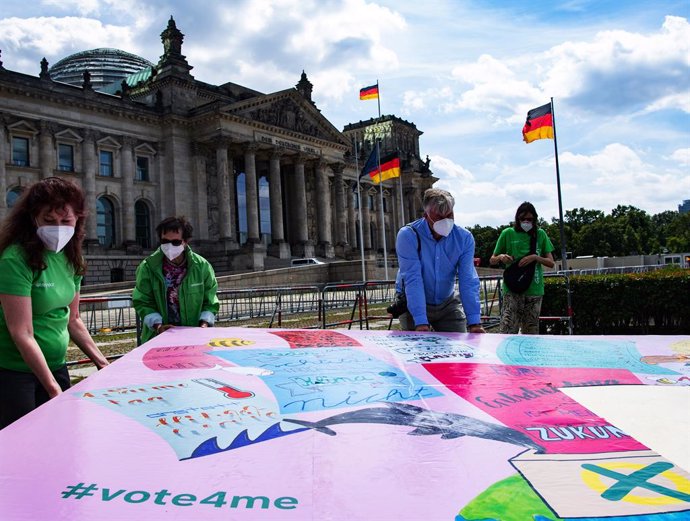 Archivo - 30 July 2021, Berlin: Environmental activists put up election posters in front of the German Reichstag building to mark the start of the "vote4me" children's campaign called by the environmental protectIon organisation Greenpeace. Photo: Paul 