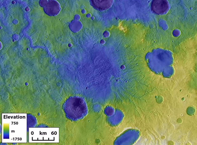Los restos de un antiguo lago de cráter en Marte rodeado por otros cráteres más pequeños. El gran cañón de salida en la parte superior izquierda se formó durante un evento de ruptura del cráter.