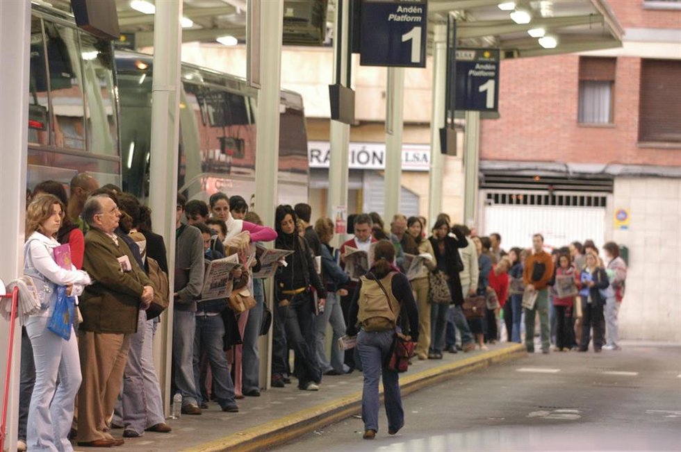 Archivo - Viajeros esperando el autobús en Gijón en una imagen de archivo.