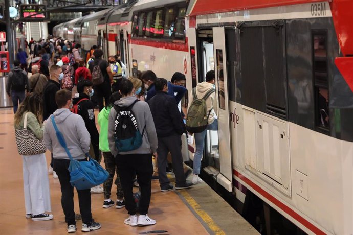 Un gran número de pasajeros entra a un tren en la estación de Madrid - Puerta de Atocha