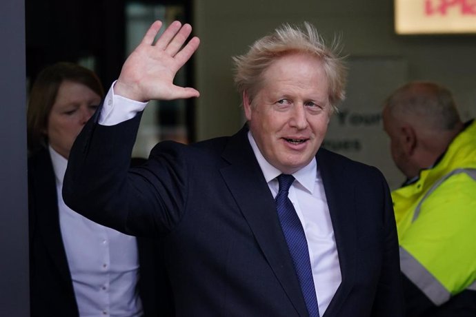 03 October 2021, United Kingdom, Manchester: UK Prime Minister Boris Johnson waves as he leaves Media City in Salford, after appearing on the BBC1 current affairs programme, The Andrew Marr Show. Photo: Jacob King/PA Wire/dpa