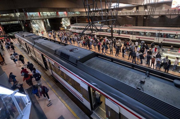 Un gran número de pasajeros espera la llegada de trenes en la estación de Madrid - Puerta de Atocha