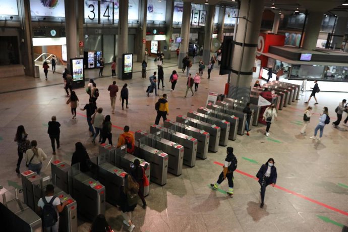 Pasajeros entran y salen por los tornos de la estación de Madrid - Puerta de Atocha