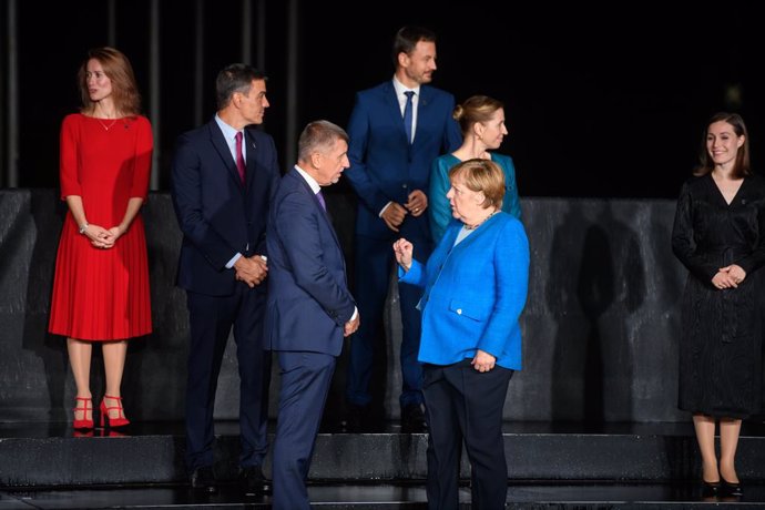 05 October 2021, Slovenia, Kranj: German Chancellor Angela Merkel (R) speaks with Prime Minister of the Czech Republic Andrej Babis  during a group photo at the EU-Western Balkans summit in Brdo Castle. Photo: Nebojsa Tejic/STA/dpa