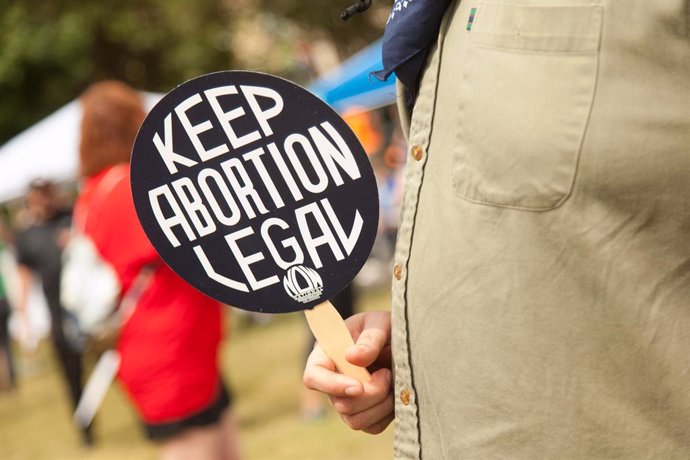 02 October 2021, US, Dallas: A woman holds up a sign at the Dallas Reproductive Liberation March at the Main Street Garden as part of a nationwide protests against the new abortion law that has come into force in Texas. The law has banned abortions from