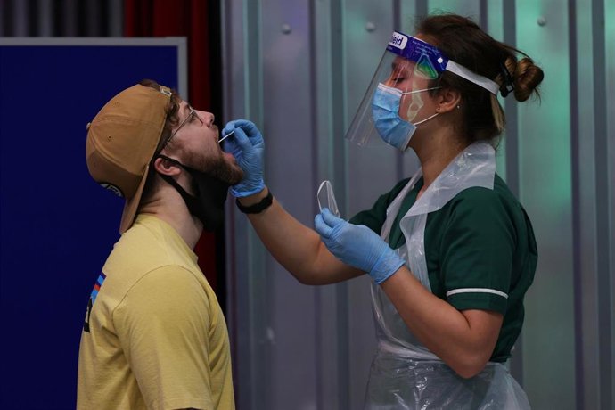 Archivo - Una mujer realiza un test a un ciudadano británico en Londres