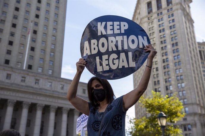 02 October 2021, US, New York: A woman holds a placard during a march through lower Manhattan as part of a nationwide protests against the new abortion law that has come into force in Texas. The law has banned abortions from the sixth week of pregnancy.