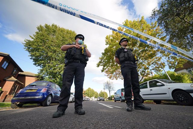 15 October 2021, United Kingdom, Leigh-On-Sea: Police officers stand at the scene near the Belfairs Methodist Church in Eastwood Road North, where Conservative lawmaker Sir David Amess has died after he was stabbed several times at a constituency surgery.