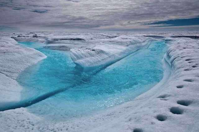 Río de deshielo sobre un glaciar en Groenlandia
