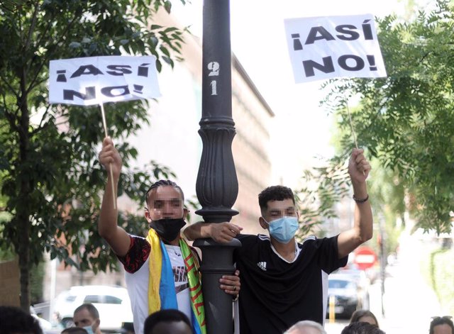 Archivo - Dos jóvenes con un cartel en el que se lee: `Así no!, en una concentración frente al Ministerio del Interior para exigir la reforma del Reglamento de Extranjería, a 10 de septiembre de 2021, en Madrid.