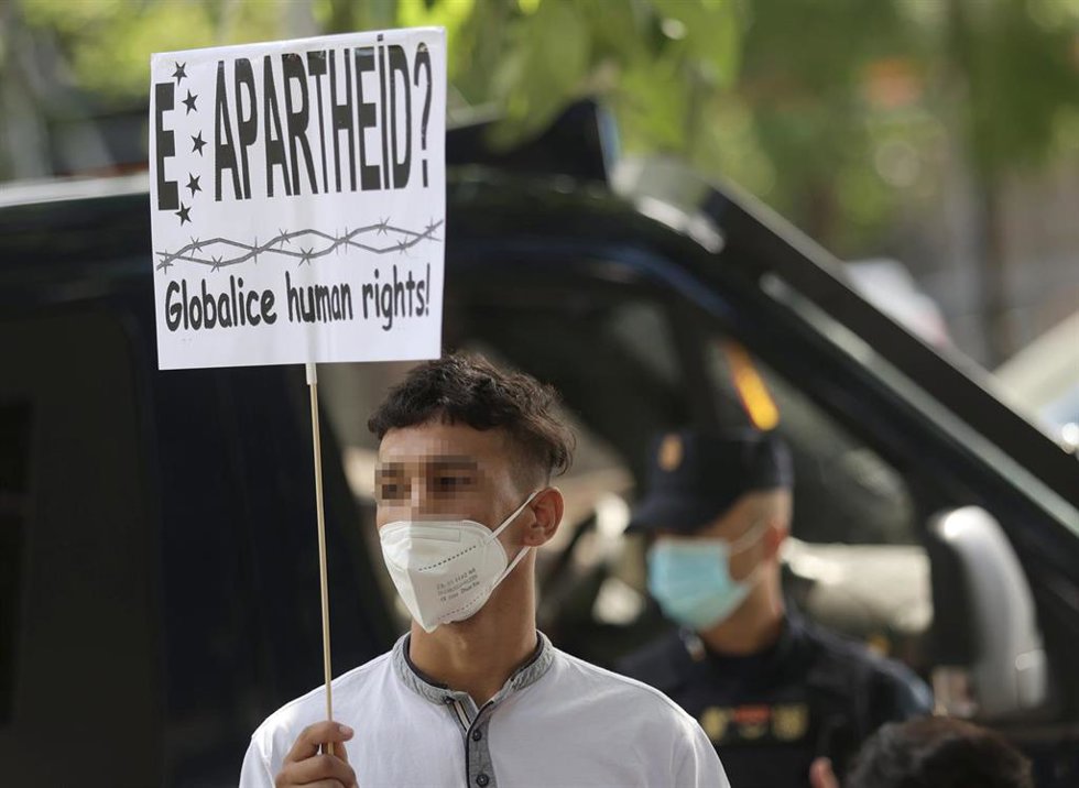 Archivo - Un joven en una concentración frente al Ministerio del Interior para exigir la reforma del Reglamento de Extranjería