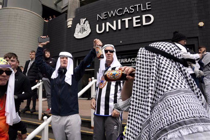 17 October 2021, United Kingdom, Newcastle: Newcastle United fans wearing the traditional Saudi ghutrah head cover are seen outside the stadium prior to the start of the English Premier League soccer match betwen  Newcastle United and Tottenham Hotspur 