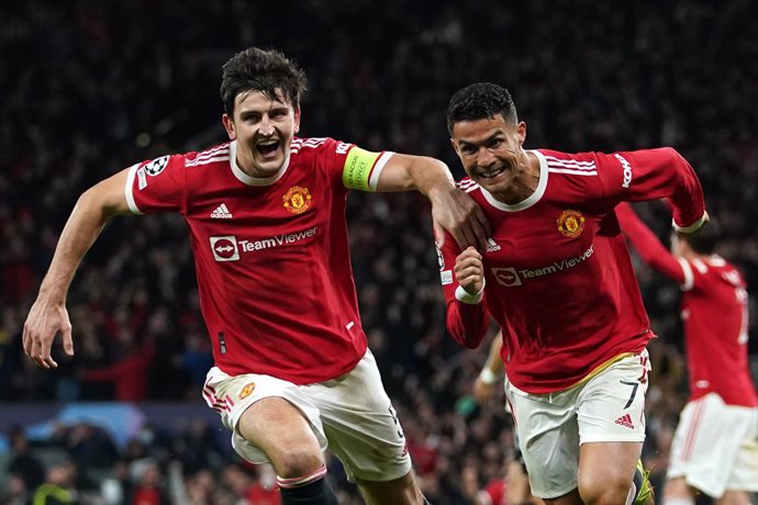 20 October 2021, United Kingdom, Manchester: Manchester United's Cristiano Ronaldo (R) celebrates scoring his side's third goal with Harry Maguire during the UEFA Champions League Group F soccer match between Manchester United and Atalanta at Old Traffo