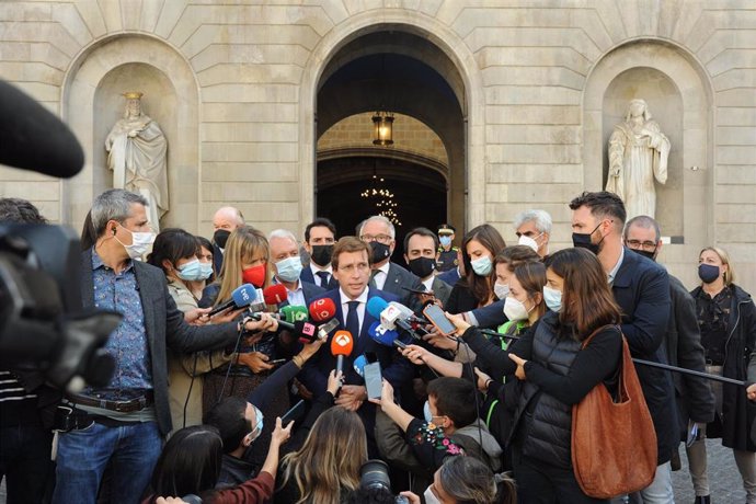 El alcalde de Madrid, José Luis Martínez-Almeida (centro), y el líder del grupo municipal del PP en el Ayuntamiento de Barcelona, Josep Bou (detrás), atienden a los medios frente al Ayuntamiento de Barcelona.